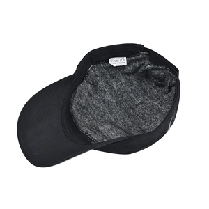 Detail of 100% cotton inner lining and wash care label inside a black military cap