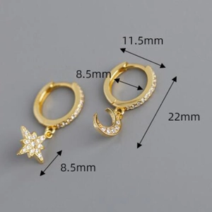 Detailed view of asymmetric star and moon earrings with diamond inlay and size measurements