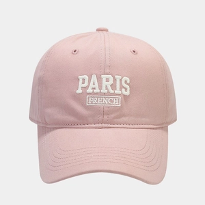 Close-up of pink cotton baseball cap featuring white embroidered Paris French lettering
