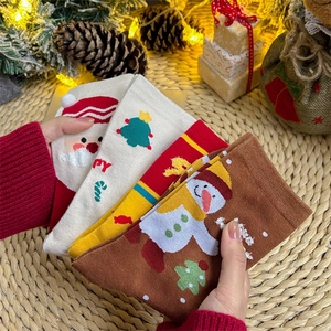 Festive Christmas cotton socks with Santa and snowman patterns in a warm gift setting