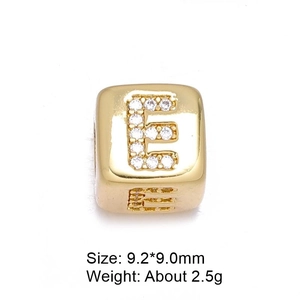 Macro shot of 8mm gold letter E bead with micro-pave cubic zirconia for DIY jewelry