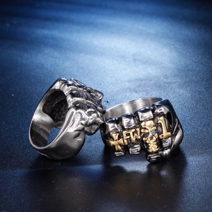 Detailed macro view of vintage fist rings with golden skull and FTW cross engraving