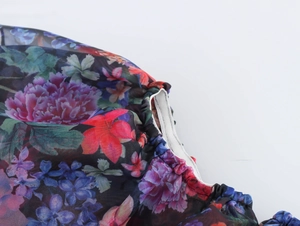 Nahaufnahme der dunklen Organza-Blumenstickerei mit elastischem Saum und weißem Futter
