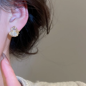 Close-up of gold-plated gourd earrings with white zircon on a model for a luxury look