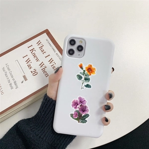 Detailed view of white smartphone case decorated with orange and purple floral PET stickers