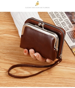 Macro view of vintage brown leather coin purse with metal kiss-lock and zipper detail