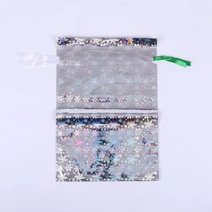 Silver laser drawstring gift bag with snowflake print and silk ribbons for Christmas