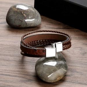 Close-up of brown multi-layer braided leather bracelet with silver magnetic metal clasp