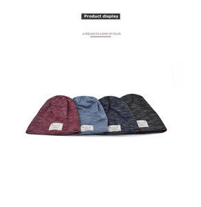 Detail view of four multi-color knit beanies with ROCK and SPORT woven labels