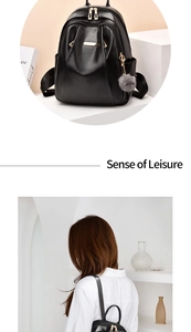 Detail of black leather backpack with gold zippers, grey fur charm, and model view