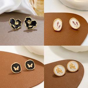 French vintage style earrings with enamel floral heart and butterfly designs on gold alloy
