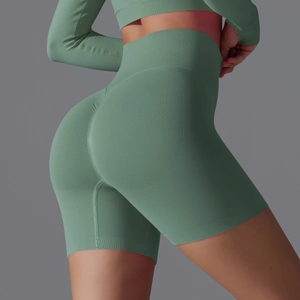 Detailed texture of seamless sage green high-waisted yoga shorts with ribbed waistband