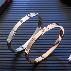 Detailed view of silver and rose gold screw design bracelets with inset diamonds