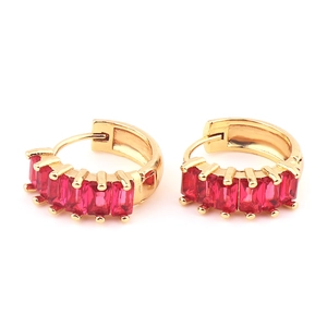 Detailed close-up of golden hoop earrings featuring inlaid rectangular red gemstones