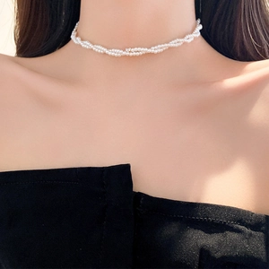 Detail shot of multi-layer twisted pearl choker necklace with a central zircon stone