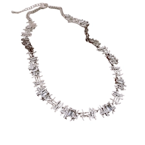 Adjustable silver thorn link necklace with rectangular zircon accents on white background