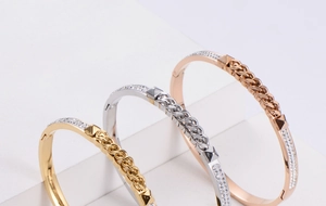 Three-tone titanium steel bangles in gold, rose gold, and silver with paved cubic zirconia