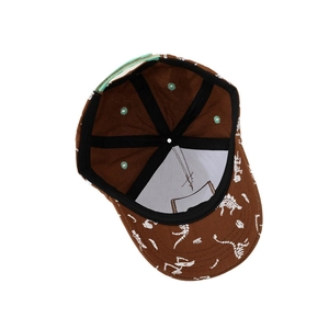 Brown kids dinosaur baseball cap featuring white skeleton print and adjustable back strap