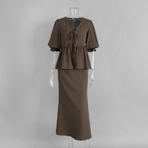 Detail of dark brown V-neck tie top with puff sleeves and matching maxi linen skirt set