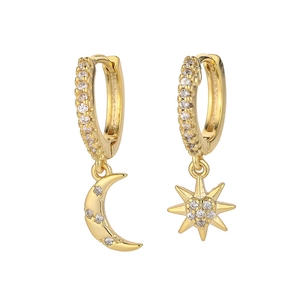 Detail view of gold huggie earrings featuring micro-pave star and moon pendants