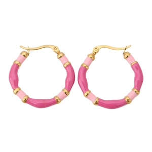 Close-up of bohemian bamboo hoop earrings with pink and magenta enamel gloss finish