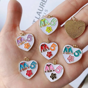 Macro shot of colorful enamel heart pendants featuring camellia and number 5 details