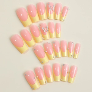 French tip press-on nails in pink and yellow with silver butterfly rhinestones set