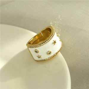 Fashionable gold-plated wide band ring with white enamel stars and zircon accents
