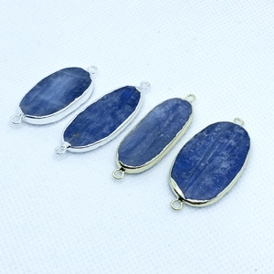 Detail of oval kyanite pendants with gold and silver plated edges for jewelry making