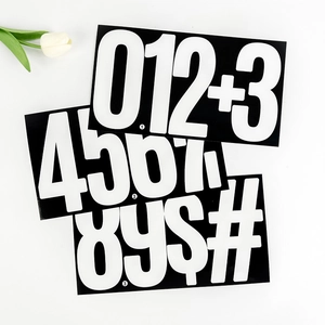 Flat lay of waterproof 6-inch black vinyl number stickers with white digits 0-9 and symbols