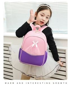 Girl wearing pink and purple ballet backpack with 3D tulle tutu and bow detail