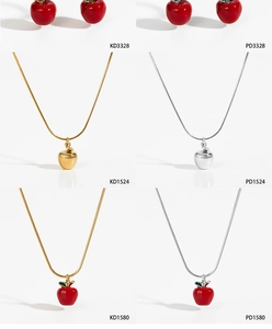Detail view of red enamel apple necklace and earrings set in gold and silver plating