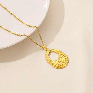 Detail showing 18k gold plated stainless steel hollow pendant with lava texture