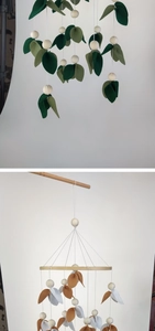 Detailed shot of felt leaves and wooden beads on handmade baby crib mobiles