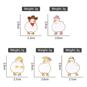 Set of five cute cartoon white duck enamel pins with colorful hats and accessories
