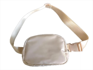 Detail of beige nylon waist bag featuring adjustable strap and secure plastic buckle