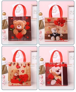 Detail of four Teddy bear gift bags with waterproof film and red handles for Valentine