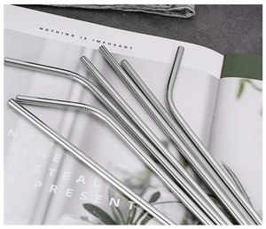 Close-up of silver stainless steel straws with anti-slip texture on a magazine