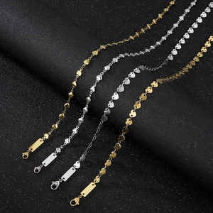 Detail of heart-shaped link necklaces in gold and silver steel with lobster clasps