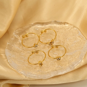 Set of 4 gold stainless steel rings with heart, flower and V-shape designs for women