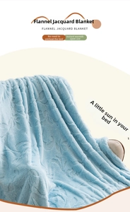 Detail of light blue flannel blanket with floral jacquard texture on beige sofa chair