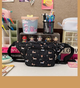 Detail of cute cartoon dachshund pattern and zipper on black crossbody chest bag