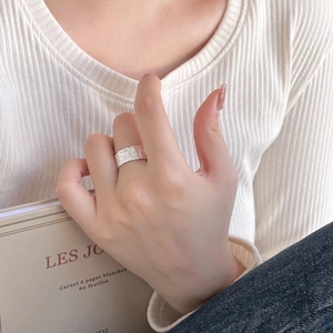 Detail of 925 sterling silver ring with unique hammered texture on model's hand