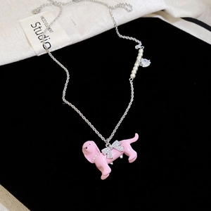 Pink puppy necklace with rhinestone bow and pearls on black velvet display