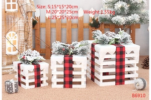Detailed size view of wooden Christmas gift boxes with snow-capped lids and plaid ribbons