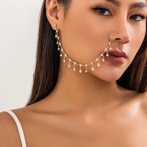 Ethnic gold nose-to-ear chain with sparkling white rhinestones on a female model