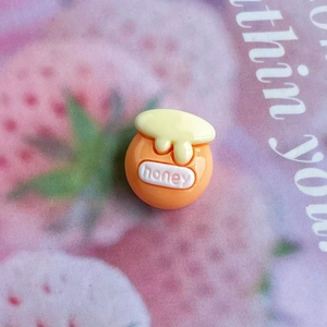 Macro detail of glossy resin honey pot charm for DIY crafts and nail art decoration