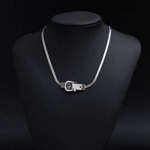 Detail of silver titanium steel necklace with a belt buckle clasp on a black bust