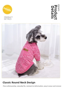 Detail of pink knitted pet sweater with ribbed crewneck and classic leather tag on a dog