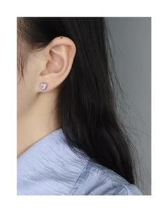 Close-up of pink heart zircon stud earring in S925 sterling silver worn on ear